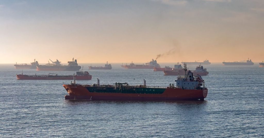 Oil and gas tankers at anchor at sunset, illustrating geopolitical risk FX and rising shipping and supply costs