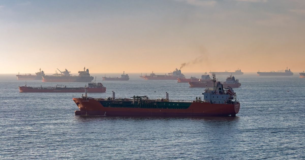 Oil and gas tankers at anchor at sunset, illustrating geopolitical risk FX and rising shipping and supply costs